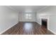 A wide view of a bright living room featuring a fireplace and hardwood floors at 2030 Hilda Burns Pl, Lithonia, GA 30058