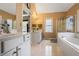 Relaxing bathroom featuring double sinks, a glass shower, and a soaking tub at 2835 Olde Town Park Dr, Norcross, GA 30071