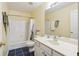 Well-lit bathroom featuring a vanity, toilet, and bathtub with shower, providing essential amenities at 2835 Olde Town Park Dr, Norcross, GA 30071