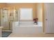 Bright bathroom featuring a luxurious soaking tub and separate shower at 2835 Olde Town Park Dr, Norcross, GA 30071