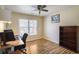 Bright bedroom with hardwood floors and a work area, offering a comfortable and functional living space at 2835 Olde Town Park Dr, Norcross, GA 30071