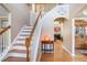 Bright foyer with hardwood floors, staircase, and decorative details at 2835 Olde Town Park Dr, Norcross, GA 30071