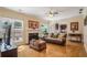 Cozy living room featuring hardwood floors, a fireplace, and bright windows at 2835 Olde Town Park Dr, Norcross, GA 30071