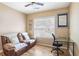 Bright home office with a comfortable seating area and functional desk space at 2835 Olde Town Park Dr, Norcross, GA 30071