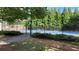 Enjoy a game of tennis on the community tennis court, surrounded by lush trees and landscaping at 2835 Olde Town Park Dr, Norcross, GA 30071