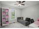 Bedroom with a large window, comfortable seating area, and built-in shelving for storage at 6909 Heritage Pl, Acworth, GA 30102