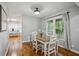 Cozy dining room boasts hardwood floors, a wood table, and natural light streaming through the window at 6909 Heritage Pl, Acworth, GA 30102