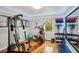 Home gym featuring exercise equipment, mirrored wall, and natural light, providing a dedicated fitness space at 6909 Heritage Pl, Acworth, GA 30102
