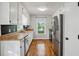 Modern kitchen showcasing stainless steel appliances, butcher block counters, and hardwood floors, illuminated by natural light at 6909 Heritage Pl, Acworth, GA 30102