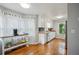 Bright kitchen area features white cabinets, stainless steel appliances, and hardwood floors for a modern touch at 6909 Heritage Pl, Acworth, GA 30102