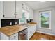Bright kitchen featuring butcher block counters, stainless steel appliances, and ample cabinet space at 6909 Heritage Pl, Acworth, GA 30102