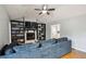 Inviting living room showcasing a stone fireplace with custom shelving, paired with a comfortable blue sofa at 6909 Heritage Pl, Acworth, GA 30102