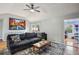 Comfortable living room featuring a plush dark sofa, accent rug, and artwork, complemented by natural light at 6909 Heritage Pl, Acworth, GA 30102