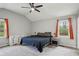 Spacious main bedroom featuring vaulted ceiling, ceiling fan, carpeted floor, and two windows with natural light at 6909 Heritage Pl, Acworth, GA 30102
