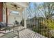 Charming balcony features wood decking, a ceiling fan, a metal railing, and outdoor seating at 865 Inman Village Ne Pkwy, Atlanta, GA 30307