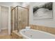 This bathroom features a luxurious soaking tub and glass shower with beautiful tile at 865 Inman Village Ne Pkwy, Atlanta, GA 30307