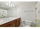 Bathroom featuring a large mirror, wood cabinets, and shower with patterned curtain at 865 Inman Village Ne Pkwy, Atlanta, GA 30307