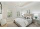 This bedroom features neutral colors, a chandelier, tray ceilings, and many windows at 865 Inman Village Ne Pkwy, Atlanta, GA 30307