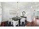 Bright dining room with a modern chandelier, wainscoting detail, and sleek black dining set and rug at 865 Inman Village Ne Pkwy, Atlanta, GA 30307