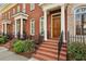 Charming red brick townhome featuring a classic facade with white pillars and a well-manicured front yard at 865 Inman Village Ne Pkwy, Atlanta, GA 30307