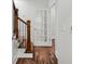 Hallway view with hardwood floors, a wooden staircase, and paneled glass doors at 865 Inman Village Ne Pkwy, Atlanta, GA 30307