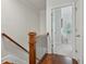 Hallway with wood floors, wooden banister and railing, and open doorway to a room with lots of light at 865 Inman Village Ne Pkwy, Atlanta, GA 30307