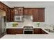 Close-up of a modern kitchen featuring stainless steel appliances, dark wood cabinets, and white subway tile backsplash at 865 Inman Village Ne Pkwy, Atlanta, GA 30307