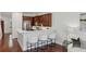 Stylish kitchen features dark wood cabinetry, stainless appliances, and white quartz breakfast bar at 865 Inman Village Ne Pkwy, Atlanta, GA 30307