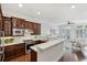 Open kitchen featuring dark wood cabinets, white countertops, and a breakfast bar overlooking the living area at 865 Inman Village Ne Pkwy, Atlanta, GA 30307