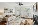 Bright living room with neutral decor, fireplace, French doors, and views of outdoor scenery at 865 Inman Village Ne Pkwy, Atlanta, GA 30307