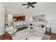 Open-concept living room with fireplace, built-in shelving, and breakfast bar seating, stylish ceiling fan at 865 Inman Village Ne Pkwy, Atlanta, GA 30307