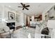 Open-concept living room with fireplace, built-ins, and breakfast bar with seating and modern ceiling fan at 865 Inman Village Ne Pkwy, Atlanta, GA 30307