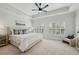 Bright primary bedroom featuring neutral décor, tray ceiling, plush carpet, and large windows at 865 Inman Village Ne Pkwy, Atlanta, GA 30307