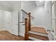 Staircase with wooden steps, dark wooden banister and railing, and white walls at 865 Inman Village Ne Pkwy, Atlanta, GA 30307