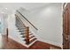 Traditional staircase with hardwood steps, wood trim, and modern black iron railings at 865 Inman Village Ne Pkwy, Atlanta, GA 30307