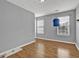 Bedroom featuring hardwood flooring, two large windows, and space for relaxing or entertaining at 240 Springbottom Ct, Lawrenceville, GA 30046