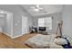 Bedroom featuring hardwood flooring, a large window, and space for relaxing or entertaining at 240 Springbottom Ct, Lawrenceville, GA 30046
