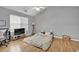 Bedroom featuring hardwood flooring, a large window, and space for relaxing or entertaining at 240 Springbottom Ct, Lawrenceville, GA 30046