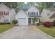 Charming two-story home with a manicured lawn, one-car garage, and inviting front porch at 240 Springbottom Ct, Lawrenceville, GA 30046