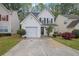Charming two-story home with a manicured lawn, one-car garage, and inviting front porch at 240 Springbottom Ct, Lawrenceville, GA 30046