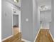 Hallway featuring hardwood flooring, neutral wall color, and doorways leading to different rooms at 240 Springbottom Ct, Lawrenceville, GA 30046