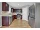 Modern kitchen with stainless steel appliances, wood cabinets, and lots of natural light at 240 Springbottom Ct, Lawrenceville, GA 30046