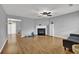 Inviting living room featuring a cozy fireplace, modern ceiling fan, and durable wood flooring at 240 Springbottom Ct, Lawrenceville, GA 30046