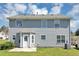The back exterior features gray siding, a patio and an enclosed back door area at 2590 Carolina Rdg, Riverdale, GA 30296