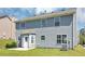 The back exterior features gray siding, a patio and an enclosed back door area at 2590 Carolina Rdg, Riverdale, GA 30296
