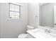 Well-lit half bathroom with a new vanity, toilet, and window at 2590 Carolina Rdg, Riverdale, GA 30296