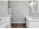 Bathroom with shower and tub combination, white vanity with sink, and wood-look floors at 2590 Carolina Rdg, Riverdale, GA 30296