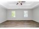 Spacious bedroom features hardwood floors, two windows, and a trey ceiling with fan at 2590 Carolina Rdg, Riverdale, GA 30296