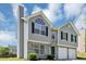 Stylish home with stone accents and a two-car garage, under a bright blue sky at 2590 Carolina Rdg, Riverdale, GA 30296