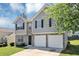 Attractive house with a two-car garage, stone accents, and neat lawn at 2590 Carolina Rdg, Riverdale, GA 30296